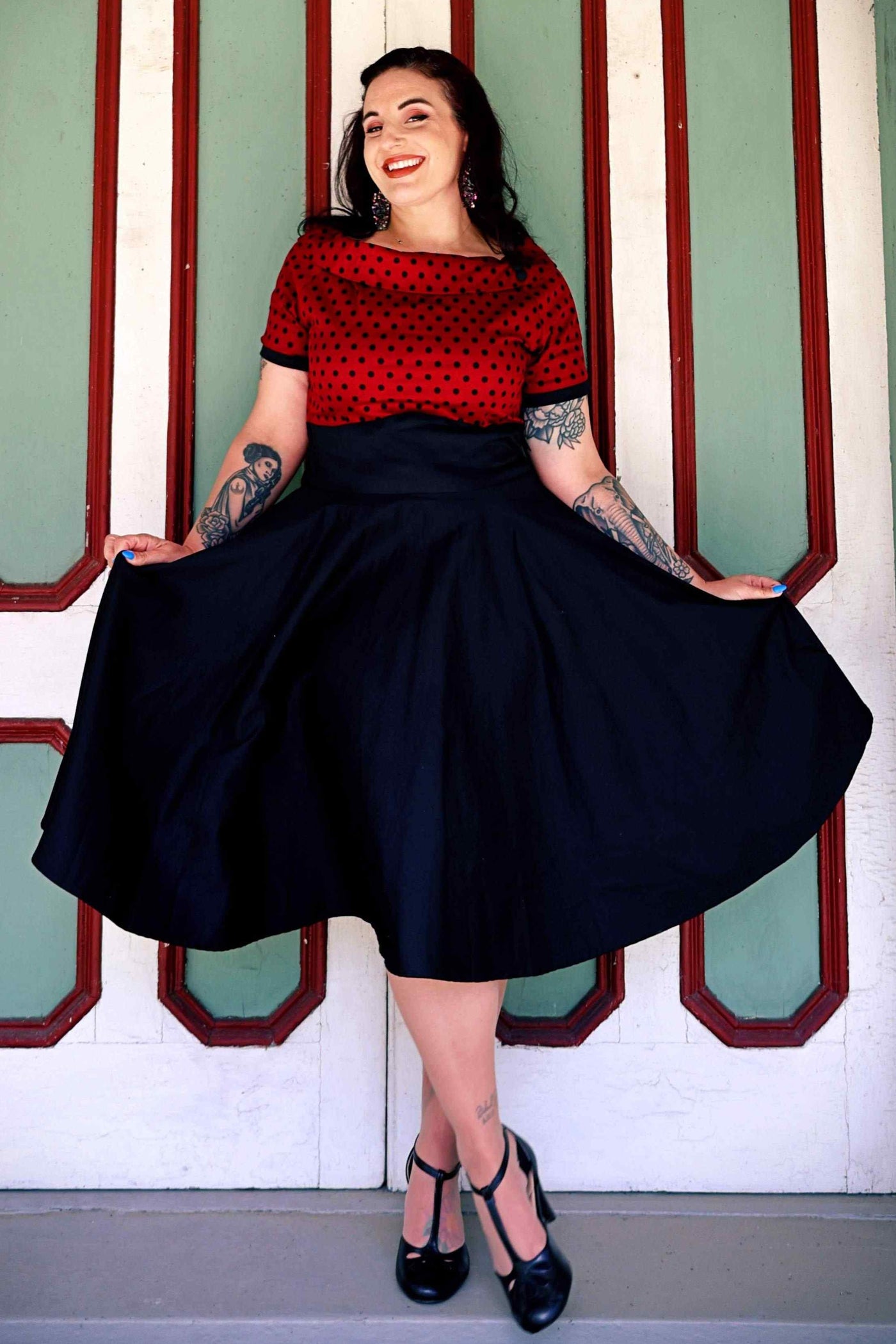 A model wearing Full Circle Swing Dress in Burgundy Polka-Black