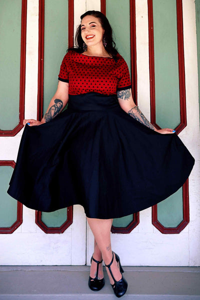A model wearing Full Circle Swing Dress in Burgundy Polka-Black