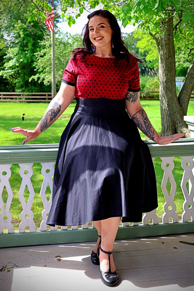 A model wearing Full Circle Swing Dress in Burgundy Polka-Black