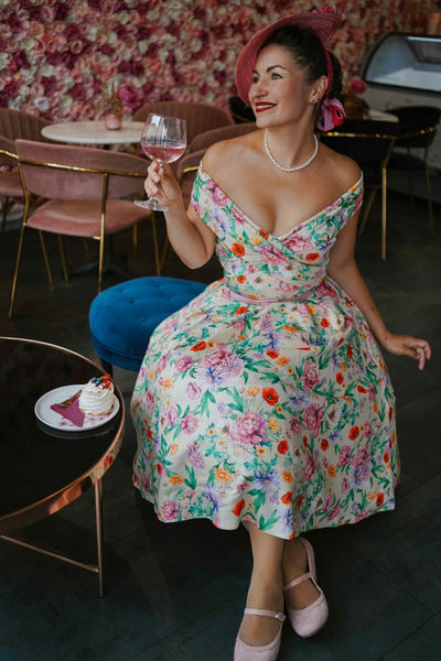 A woman in Beverly Garden Floral Off Shoulder Dress In Mint Green 