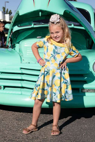 A girl wearing a Darlene Flared Dress in Blue Lemon