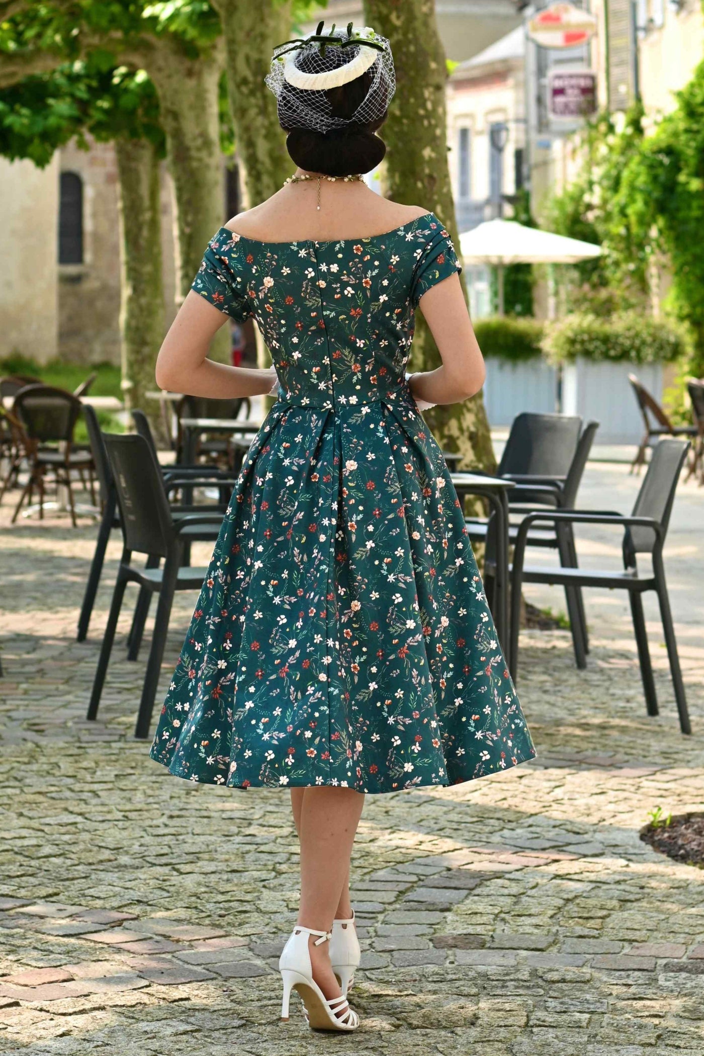 Back view of a woman wearing a Green Ditsy Floral Off Shoulder Flared Dress