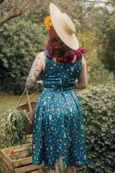 A lady wearing a Green Gardening Print Swing Dress