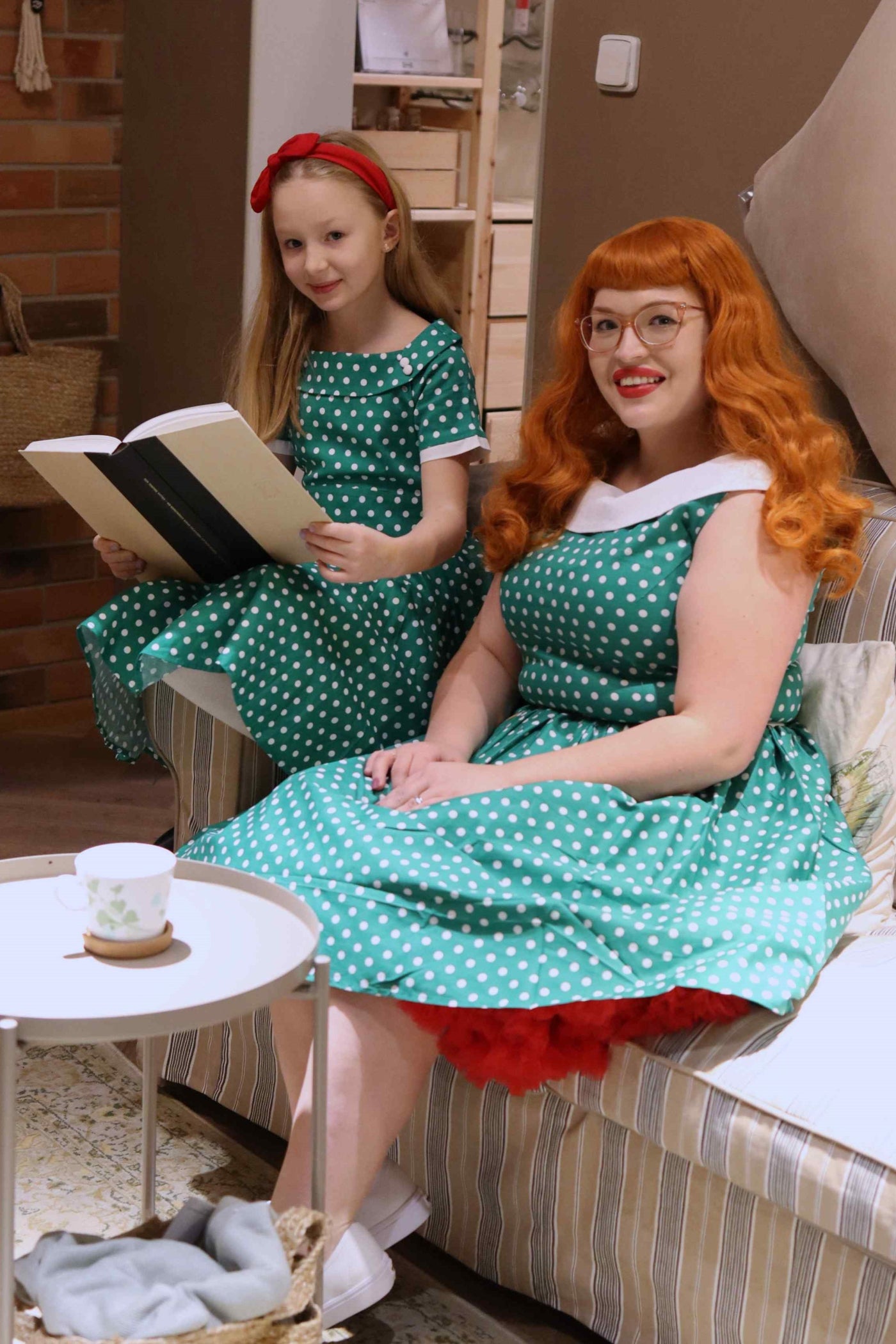 Customers wear matching mother and daughter Darlene dresses, dark green polka dot prints