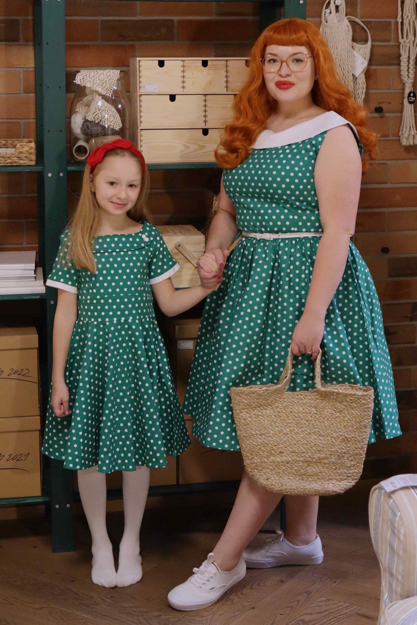 Customers wear matching mother and daughter Darlene dresses, dark green polka dot prints