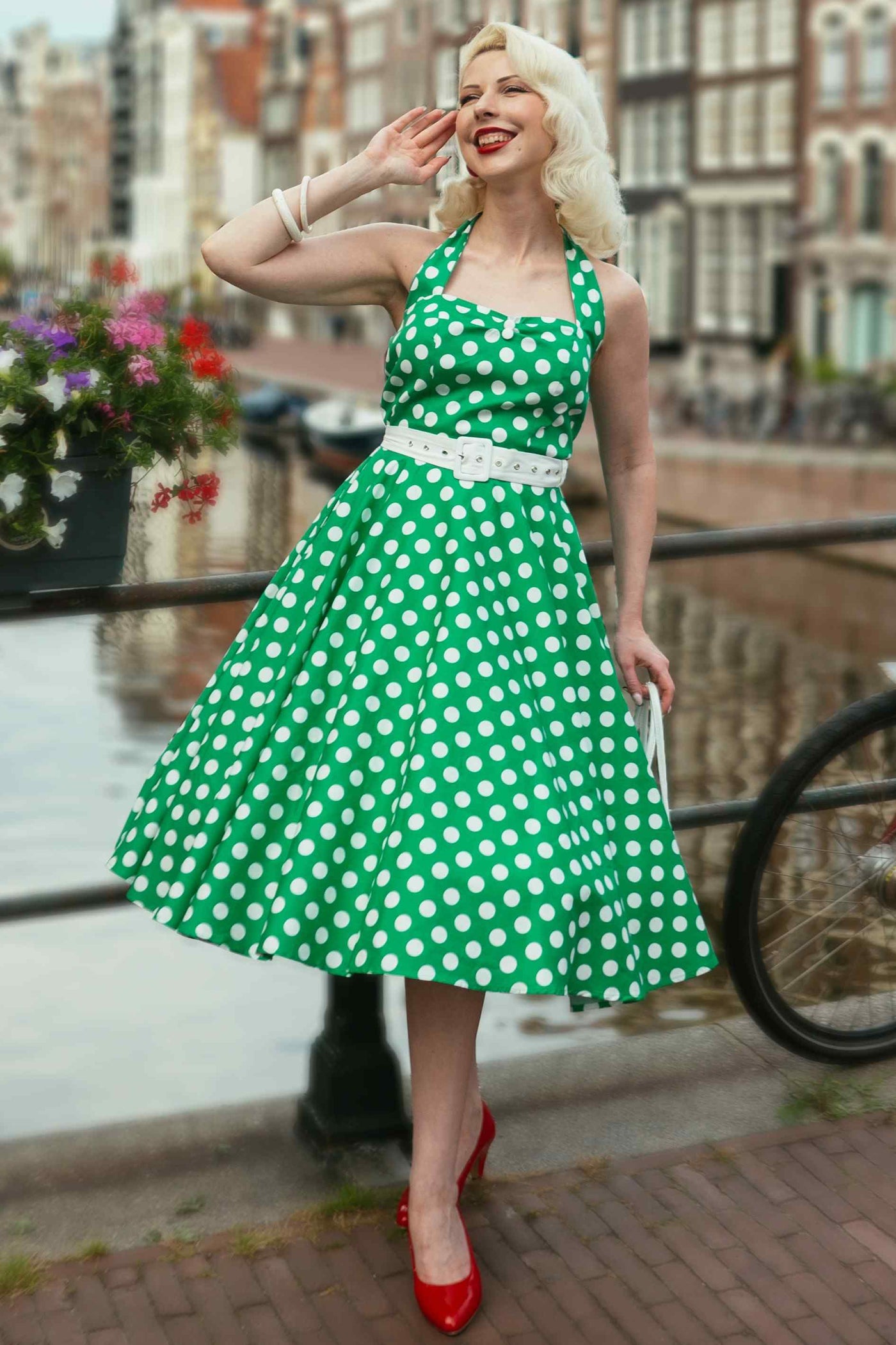 A lady wearing a Daisy Green Polka Dot Halter Dress