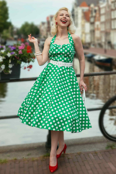 A model wearing a Daisy Green Polka Dot Halter Dress