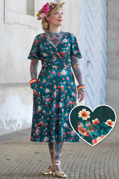 A model wearing a Green Vintage Floral Crossover Bust Dress