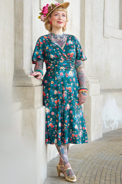 A model wearing a Green Vintage Floral Crossover Bust Dress
