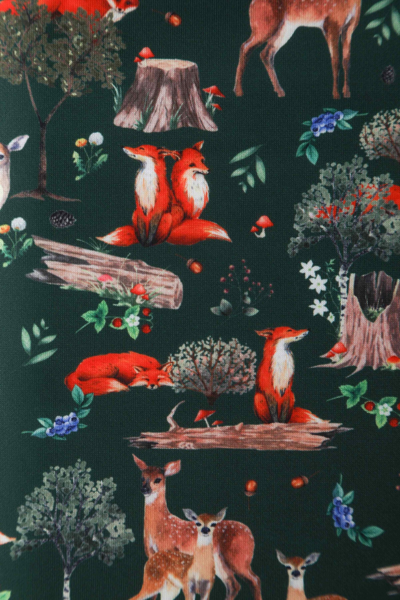 Close up view of green woodland fox and deer print sleeveless swing dress