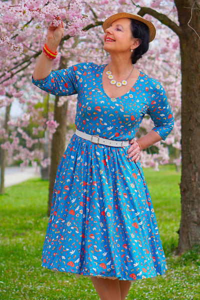 A lady wearing a Groovy Turquoise Long Sleeved Dress