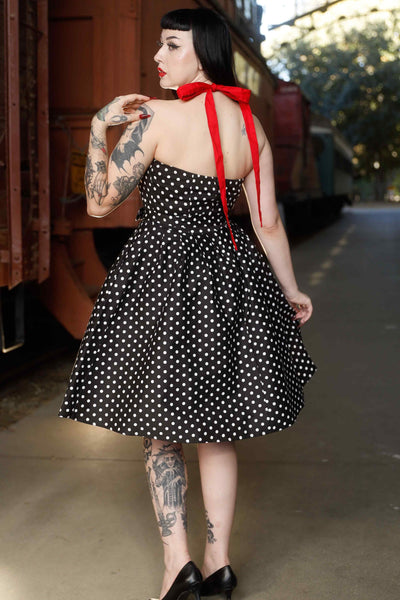 Back view of model wearing Halterneck Black Polka Dot Swing Dress