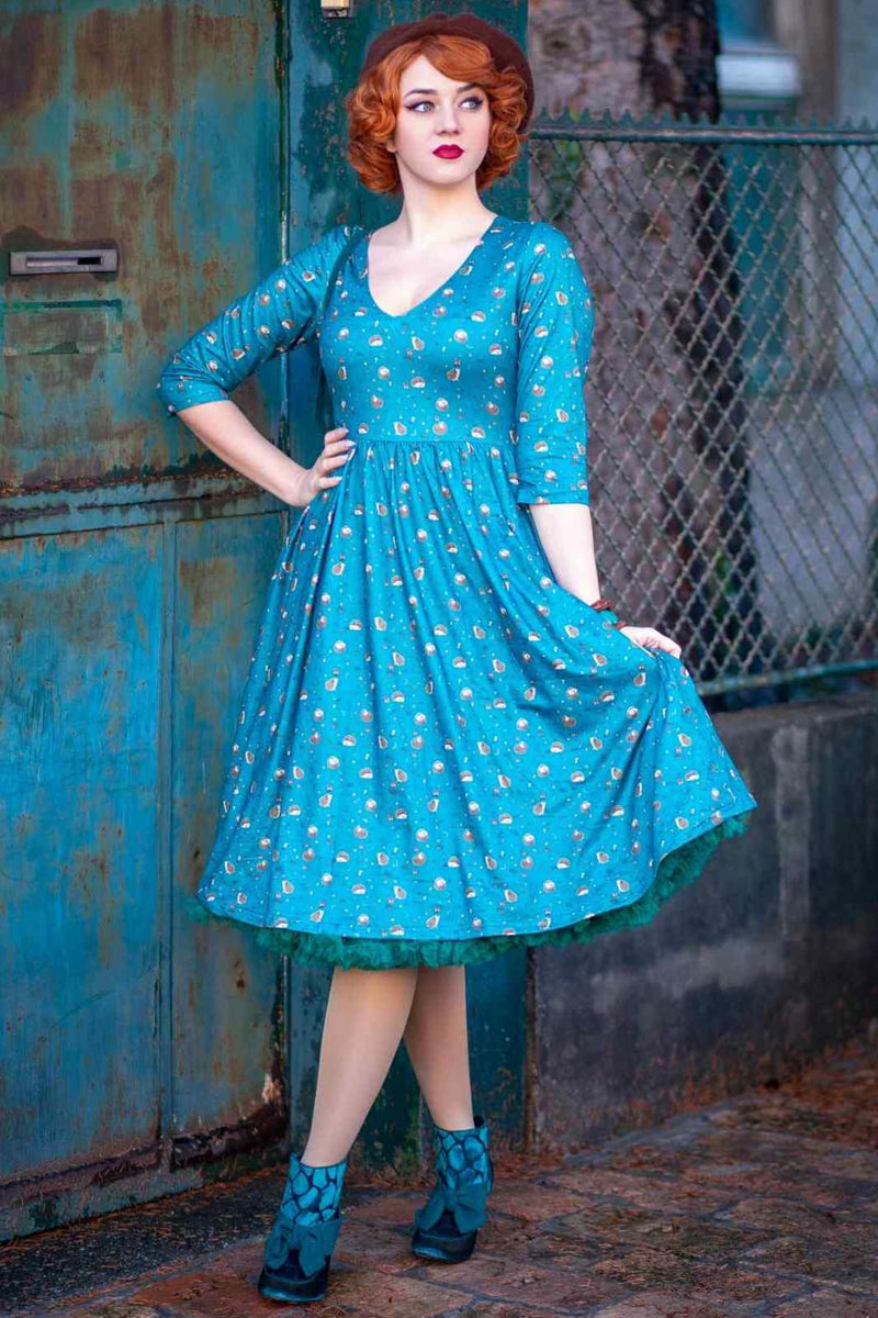 A lady wearing a Green Hedgehog & Mushroom Print Dress