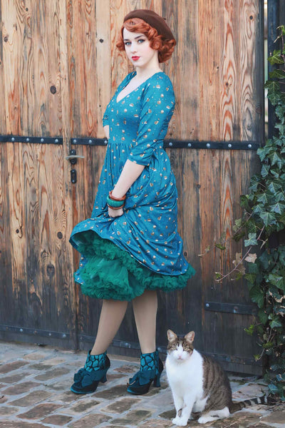A lady wearing a Green Hedgehog & Mushroom Print Dress