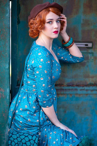 A lady wearing a Green Hedgehog & Mushroom Print Dress