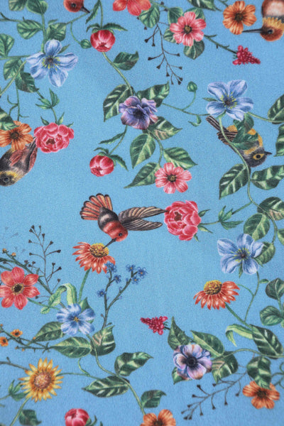 Close up view of Hummingbird Print Long Sleeved Dress in Blue