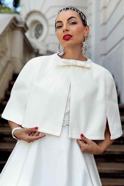 A lovely model wearing a Sabrina Ivory White Cape Jacket