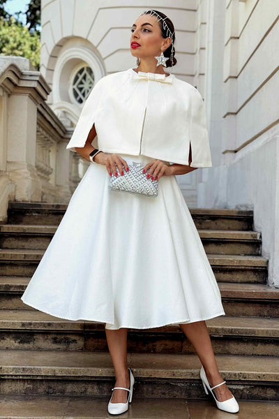 A model wearing a Sabrina Ivory White Cape Jacket