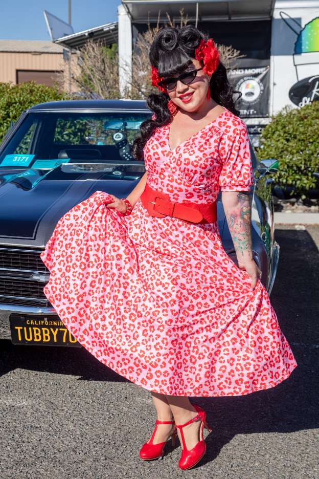 A lady wearing a Julia Pink Cheetah Print Midi Dress