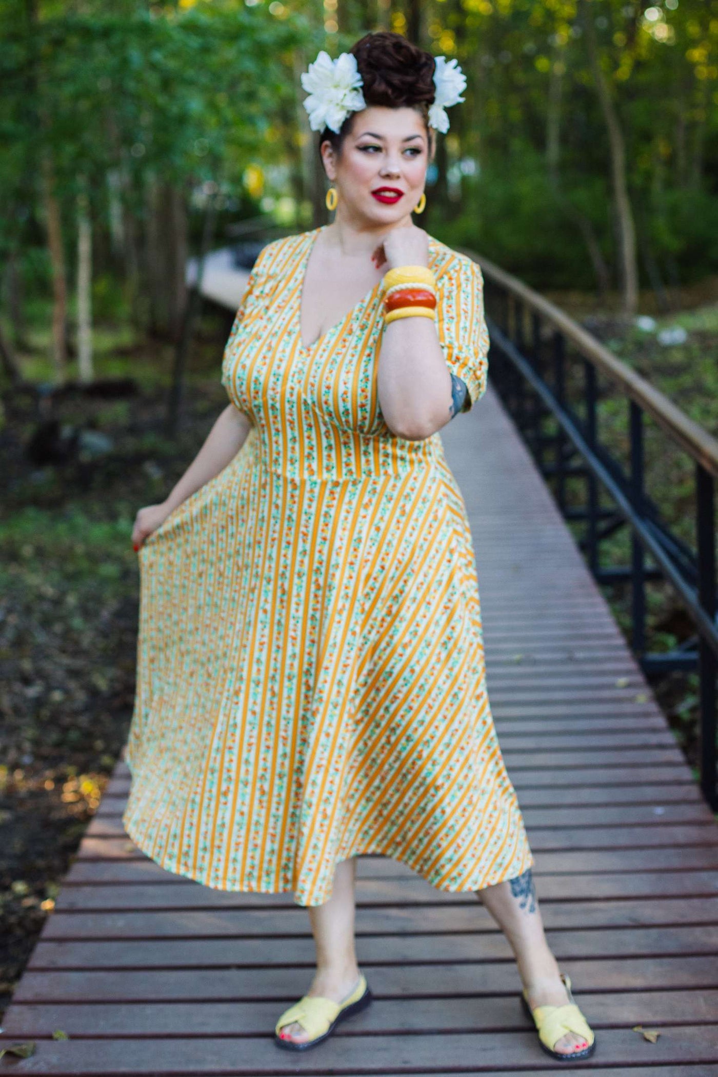 A lady wearing a Julia Sicilian Orange Midi Dress