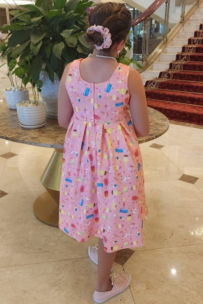 A pretty girl wearing a Kids Pink Ice Lolipop Flared Dress