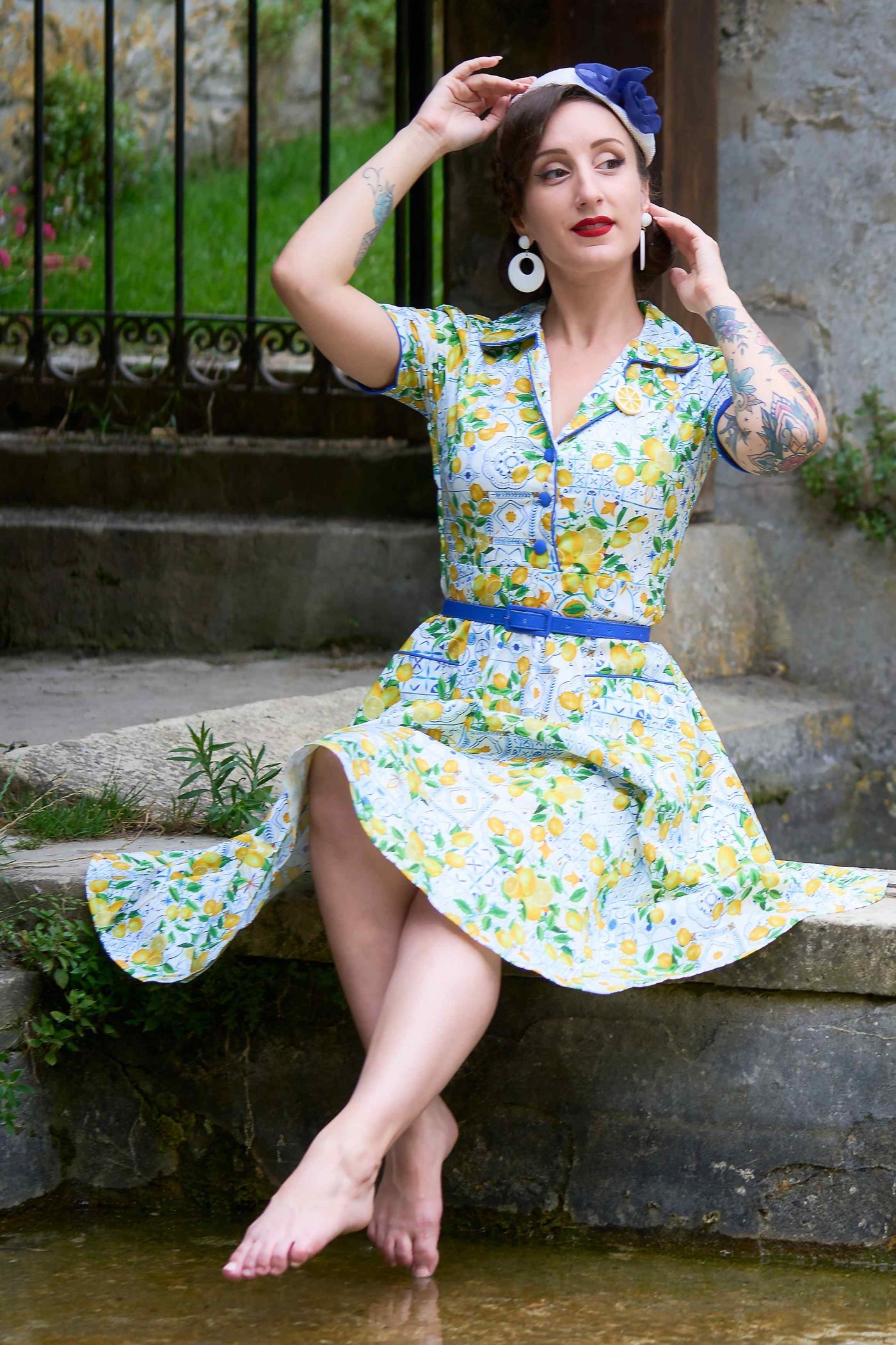 A lovely model wearing a Mabel Mediterranean Lemon Midi Shirt Dress In White