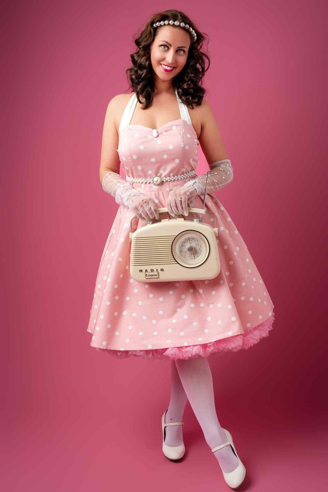 A lady wearing a Light Pink Polka Dot Halterneck Dress