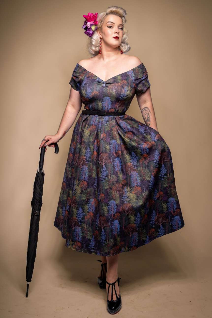 A lady wearing a Lily Autumn Foliage Off Shoulder Dress