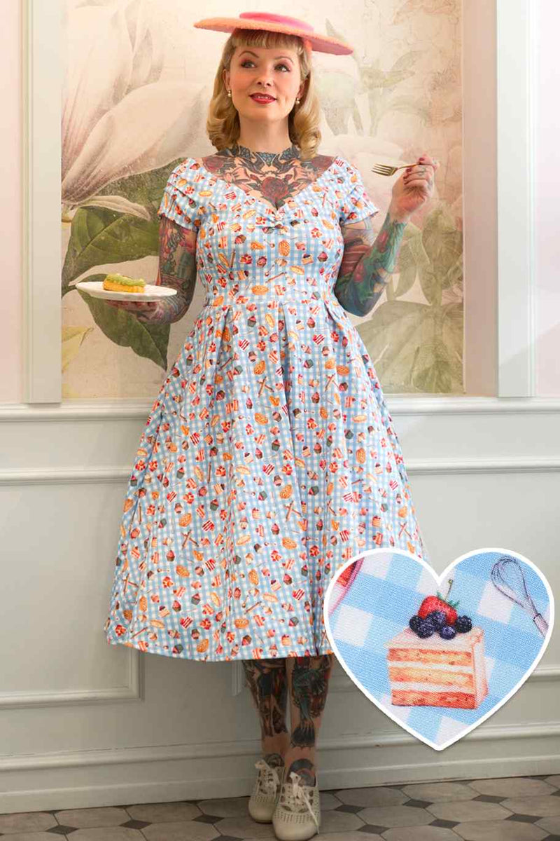 A model wearing Blue Gingham Off Shoulder Dress In Baking Print