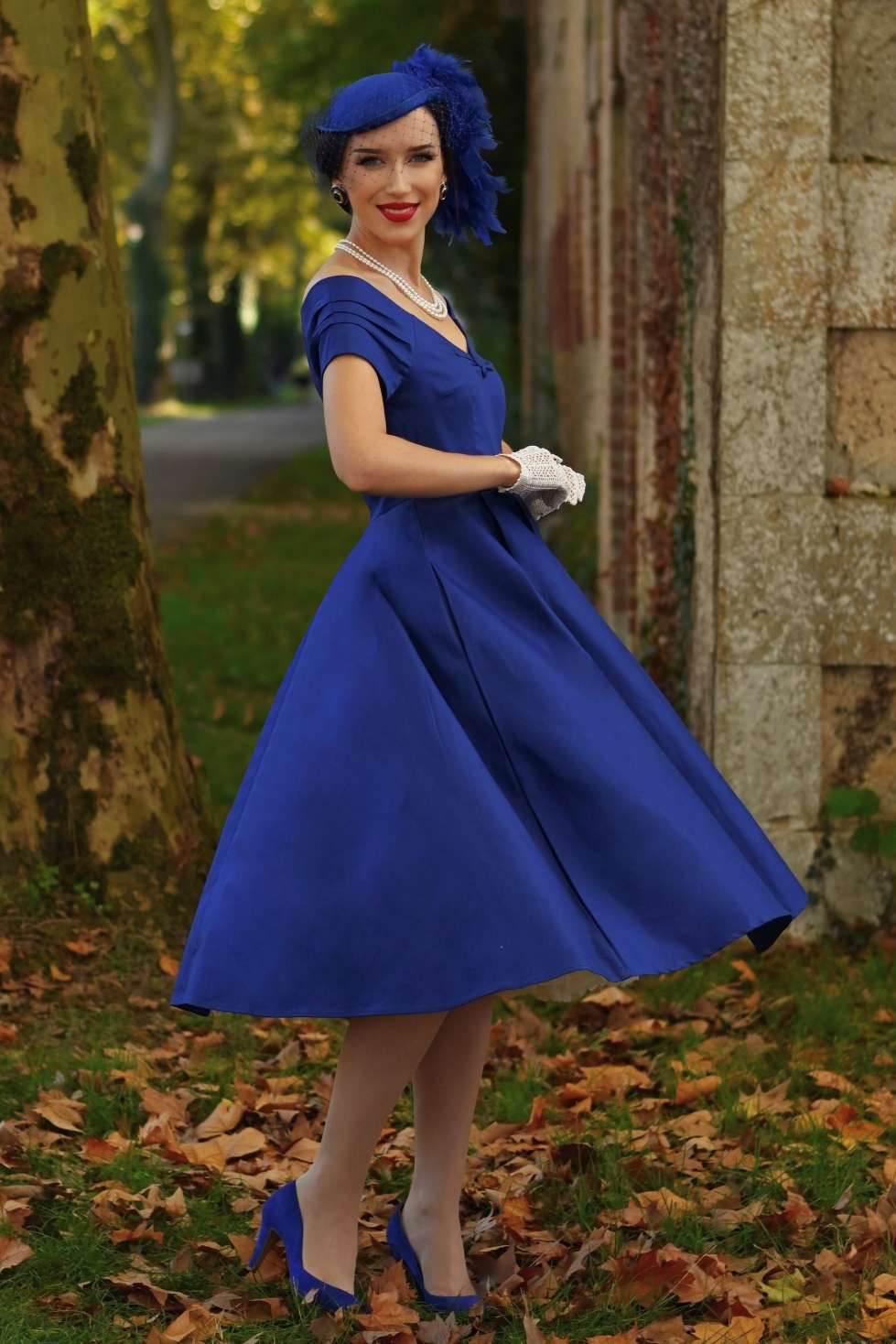 A charming model wearing a Lily Dark Blue Off Shoulder Dress