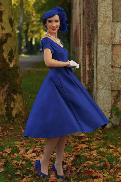 A charming model wearing a Lily Dark Blue Off Shoulder Dress