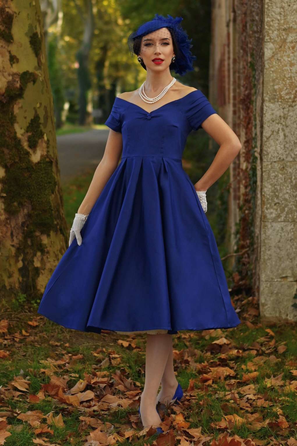 A graceful model wearing a Lily Dark Blue Off Shoulder Dress
