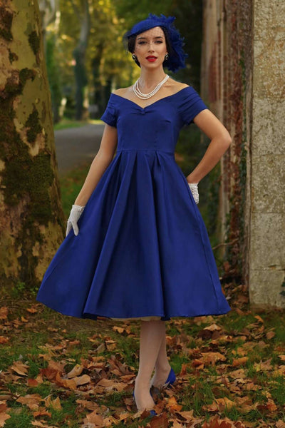 A graceful model wearing a Lily Dark Blue Off Shoulder Dress