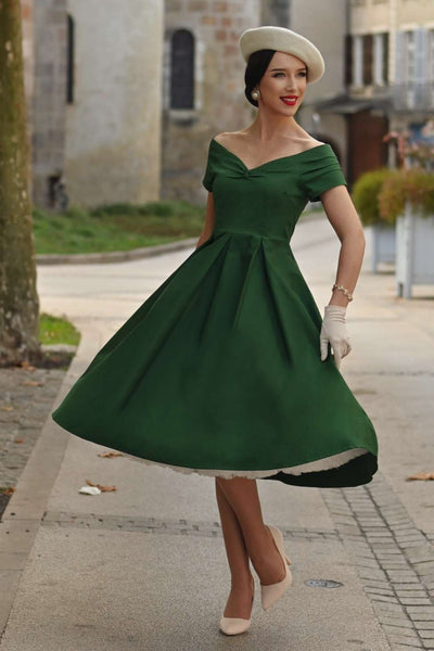 A lady wearing a Lily Dark Green Off Shoulder Dress