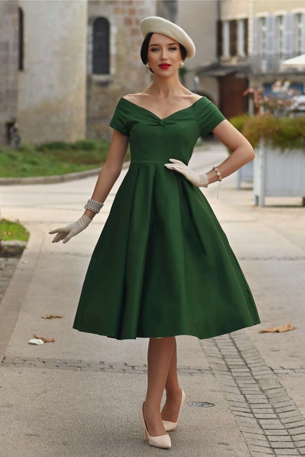 A woman wearing a Lily Dark Green Off Shoulder Dress