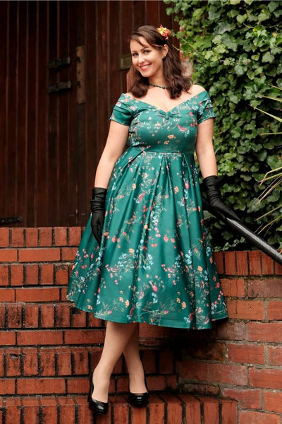 A charming model wearing a Lily Green Bird Forest Off Shoulder Swing Dress