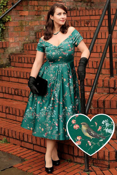 A lady wearing a Lily Green Bird Forest Off Shoulder Swing Dress