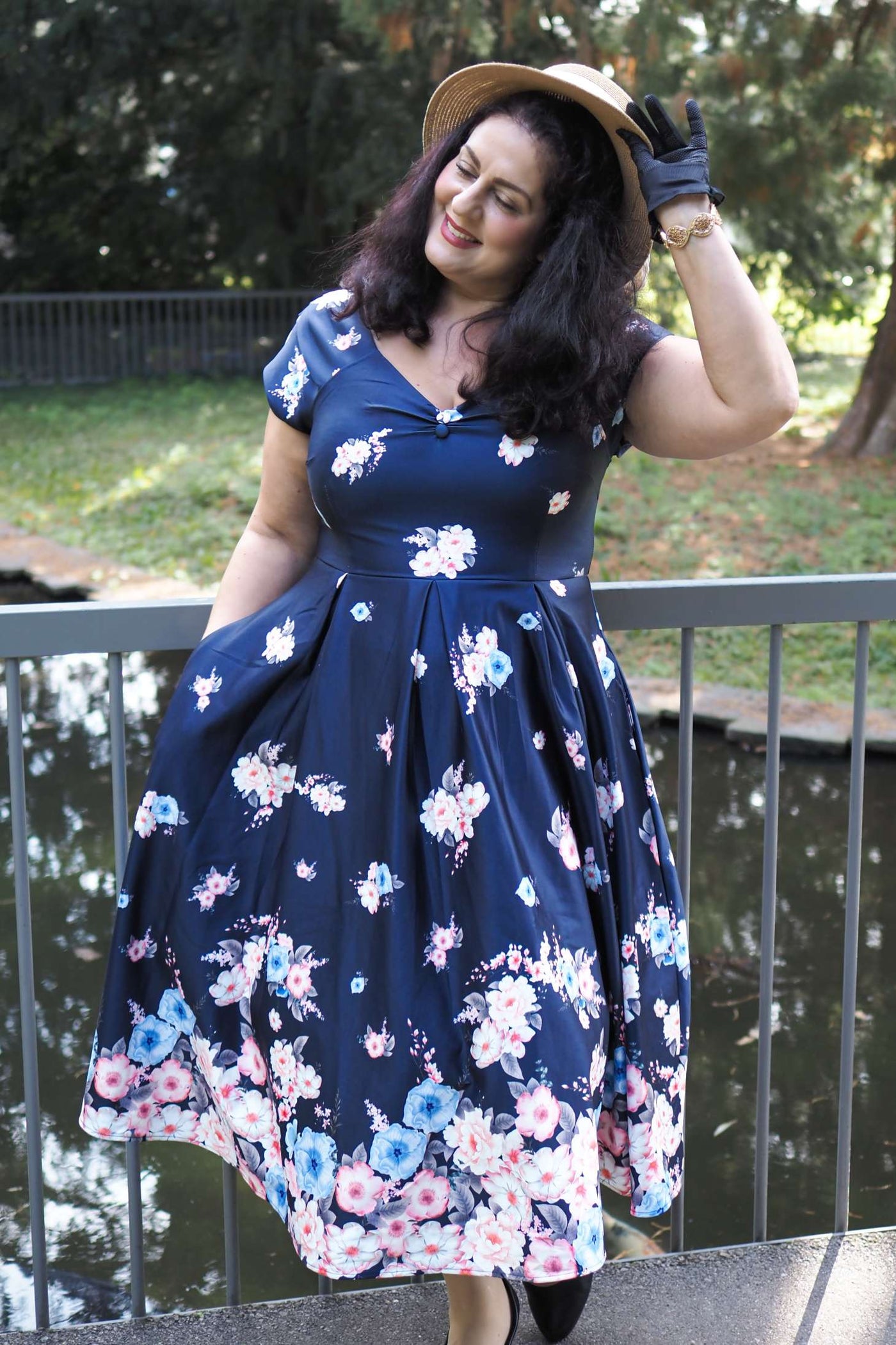 A model wearing a Lily Navy Blue Falling Rose Off Shoulder Dress