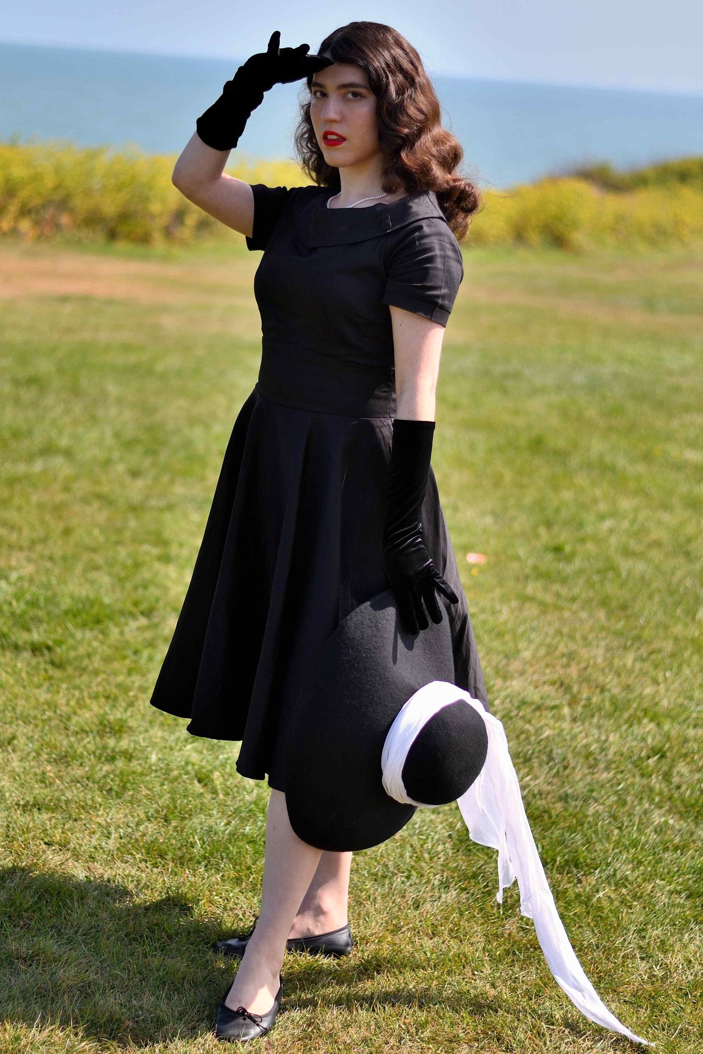 A woman wearing a Darlene Little Black Dress