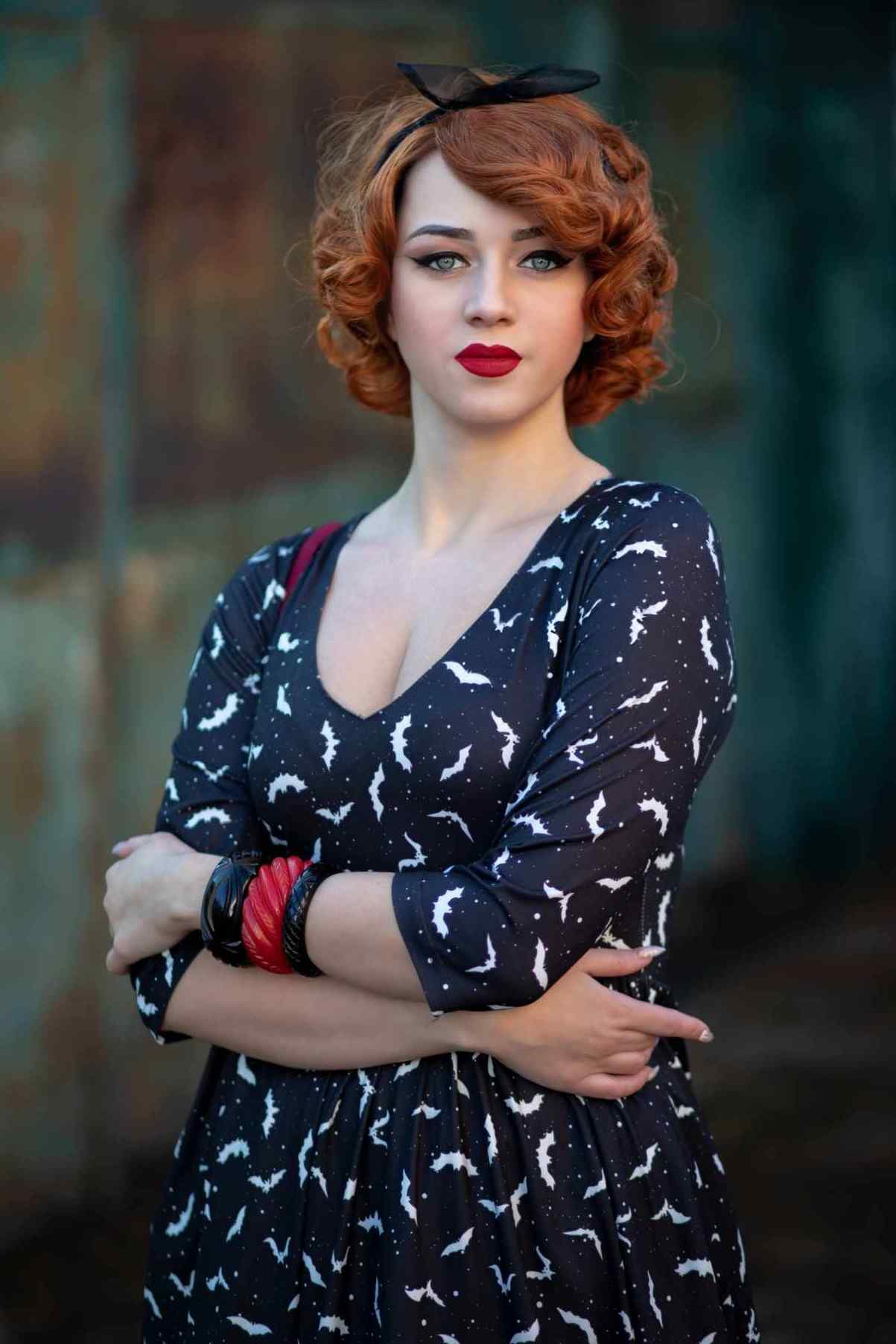 A lady wearing a Long Sleeved Black Bat Dress