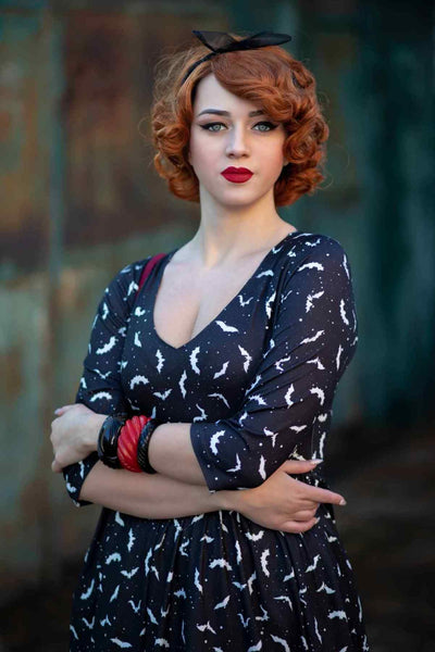 A lady wearing a Long Sleeved Black Bat Dress