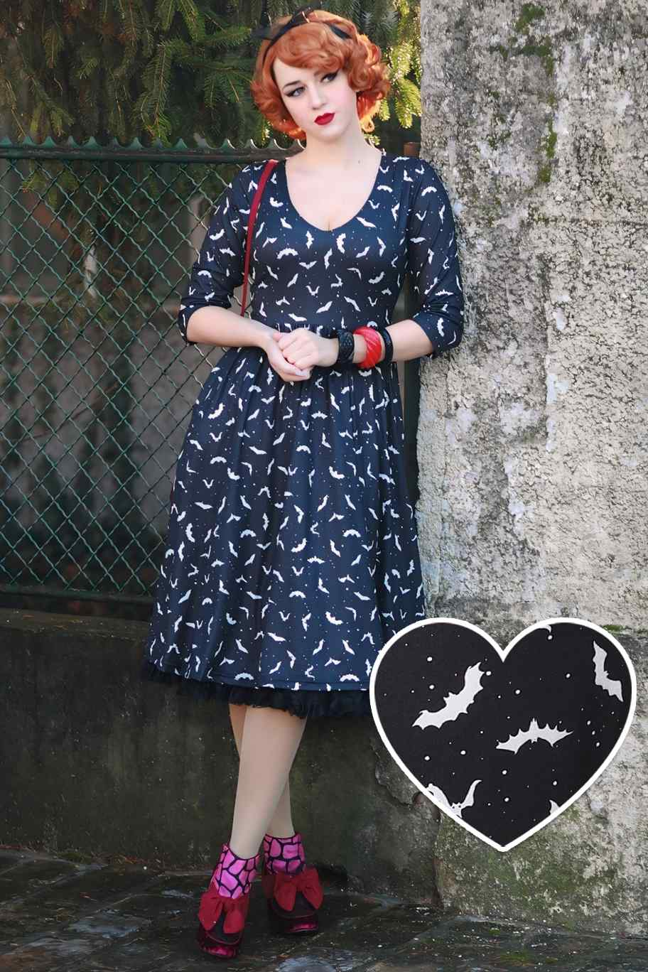 A lady wearing a Long Sleeved Black Bat Dress