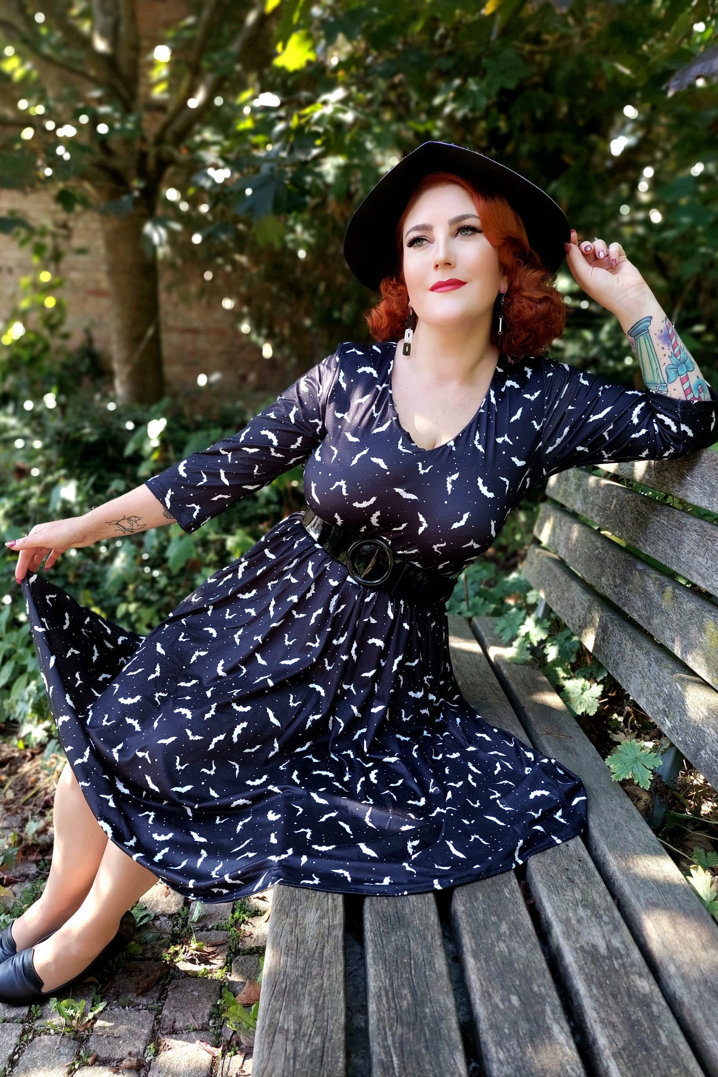 A lady wearing a Long Sleeved Black Bat Dress