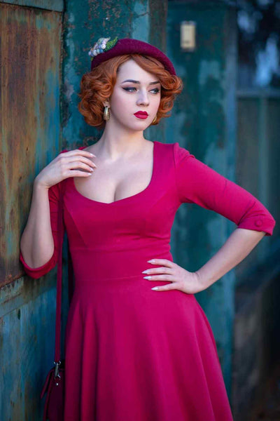 A lady wearing a Long Sleeved Burgundy Midi Dress