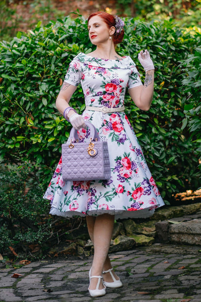 Woman wearing our Darlene Retro Floral Swing Dress in White