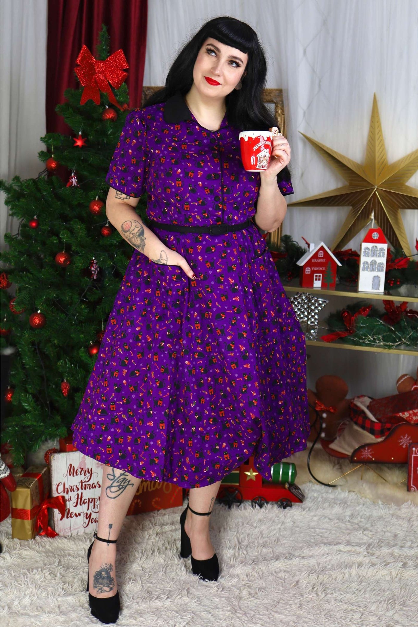 A lovely model wearing a Mabel Festive Cat Shirt Dress In Purple