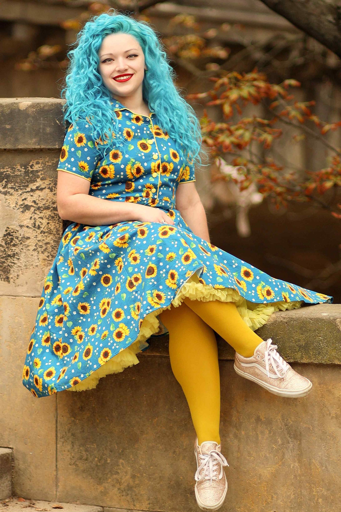 A charming model wearing a Mabel Sunflower Midi Shirt Dress In Blue