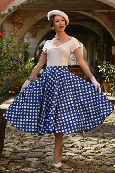 A model wearing a Maisie Navy Polka Dot Full Circle Midi Skirt