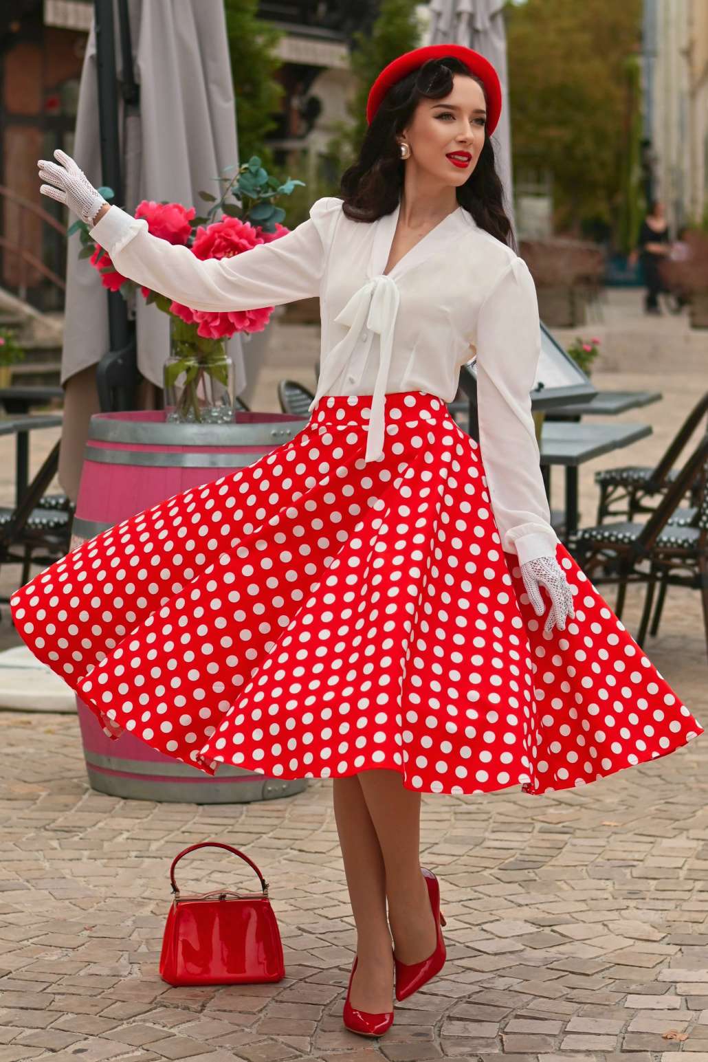 A charming model wearing a Maisie Red Polka Dot Full Circle Midi Skirt
