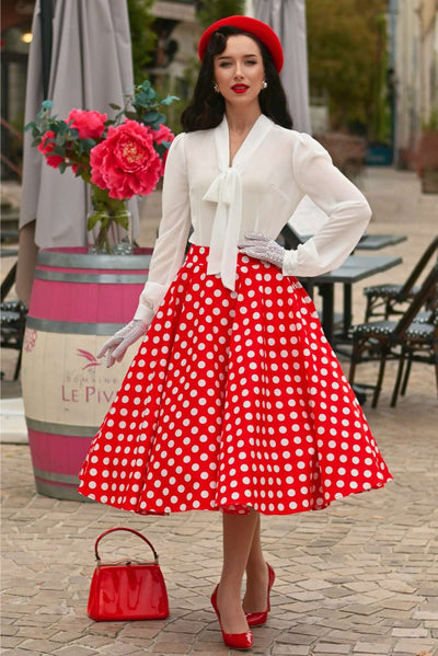 An elegant model wearing a Maisie Red Polka Dot Full Circle Midi Skirt